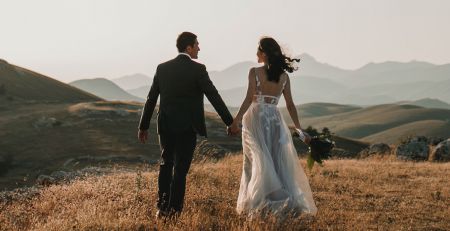 Bride and Groom standing together in nature